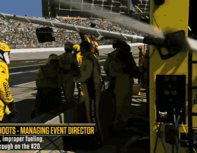 a group of men in yellow racing suits are standing in a pit lane with the words " shoots - managing event director " above them