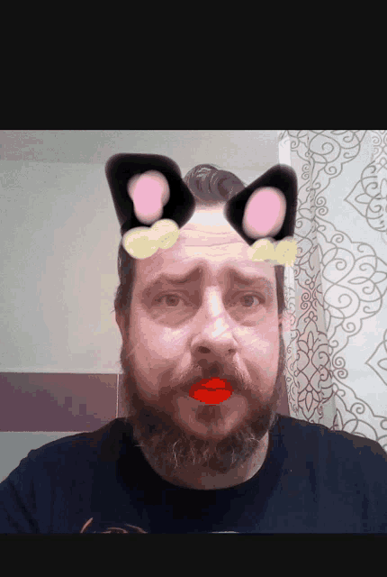 a man with a beard is wearing a cat ear filter on his face