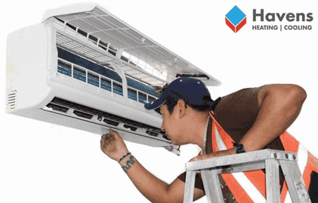 a man on a ladder working on an air conditioner with a havens heating and cooling logo in the background