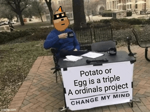 a man is sitting at a table with a sign that says potato or egg is a triple ordinals project change my mind