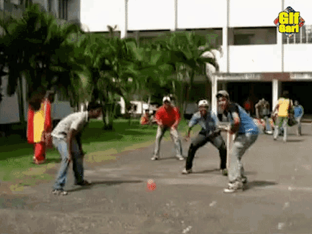 a group of young men are playing a game of soccer on a sidewalk in front of a building .