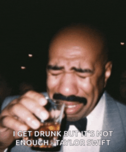 a bald man with a mustache is drinking from a shot glass and crying