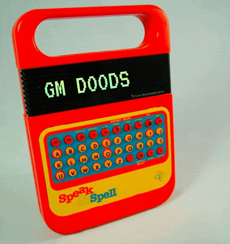 a texas instruments speak spell device with gm doods on the screen