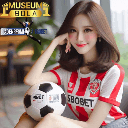 a woman in a red and white striped shirt is holding a soccer ball that says sbobet on it