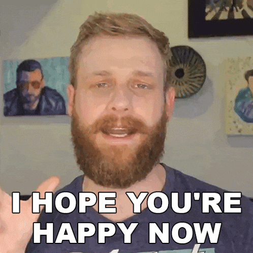 a man with a beard is giving a thumbs up and saying i hope you 're happy now