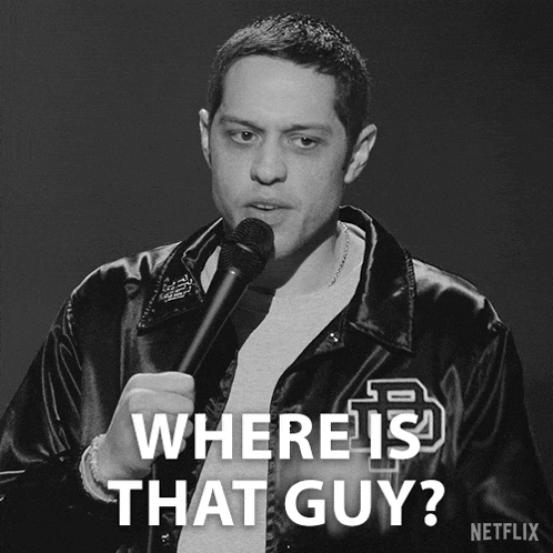 a black and white photo of a man holding a microphone with the caption where is that guy netflix