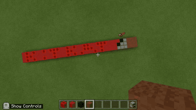 a screenshot of a minecraft game showing a red block with the word rt on it