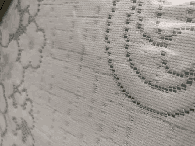 a close up of a white cloth with a pattern