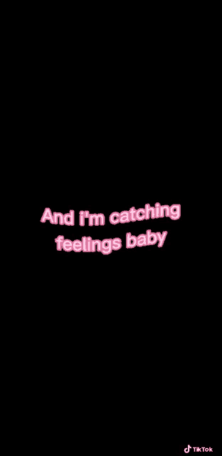 a black background with pink letters that say `` and i 'm catching feelings baby ''