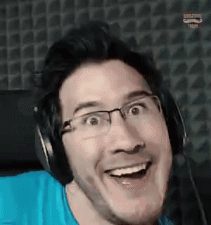 a man wearing glasses and headphones is smiling while making a funny face .