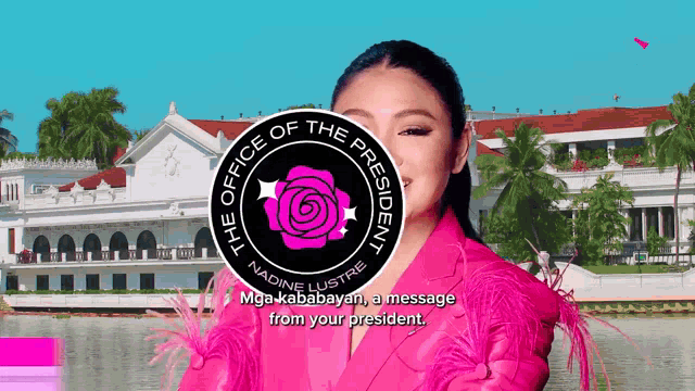 a woman in a pink jacket is standing in front of a building that says the office of the president