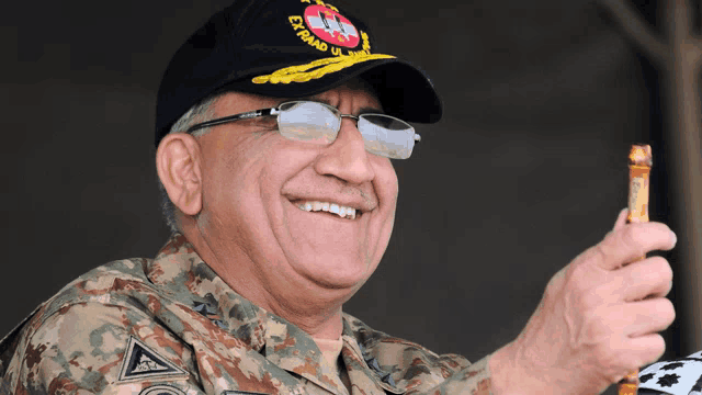 a man in a military uniform is smiling and wearing a hat that says ' ey abad ' on it