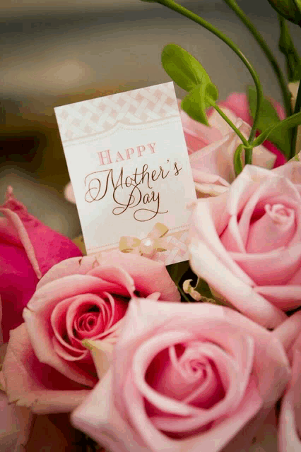 a bouquet of pink roses with a card that says " happy mother 's day "