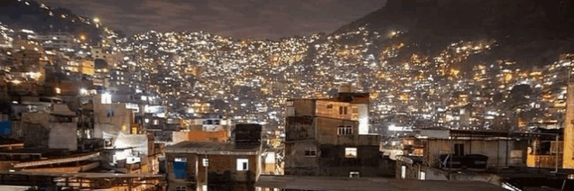 a city is lit up at night with lots of lights on the buildings