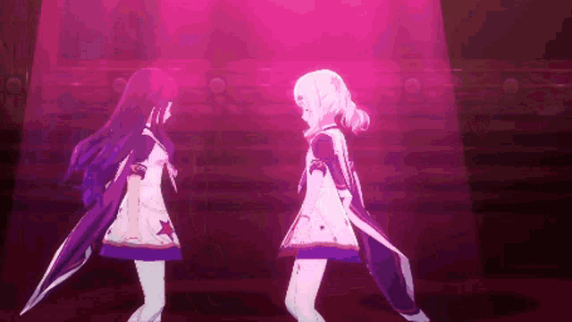 two anime girls are standing next to each other on a stage in a pink light .