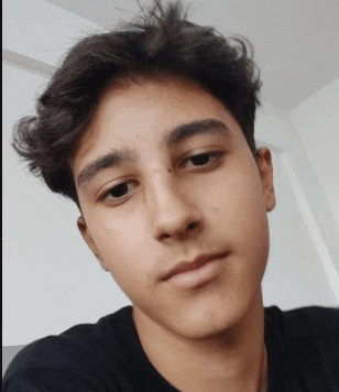 a close up of a young man 's face with a black shirt