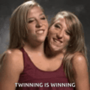 two women are standing next to each other and smiling with the words winning is winning on the bottom .