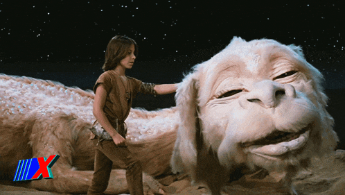 a boy standing next to a large white animal with the letter x on the bottom