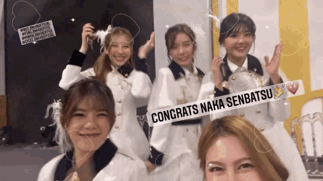 a group of girls are posing for a picture with a banner that says congrats maha senbatsu