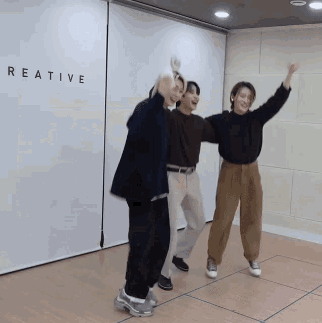 a group of people are dancing in front of a wall that says reative