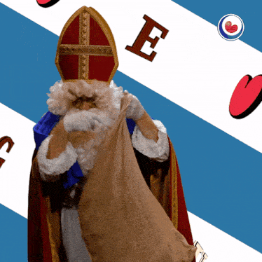 a man in a santa costume is holding a bag with the letter e above his head