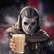 a person wearing a skull mask is holding a cup of coffee .