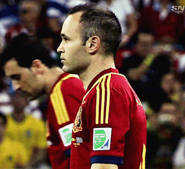 a man in a red and yellow jersey with the number 2 on it