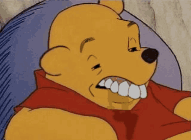 a close up of a cartoon character , winnie the pooh , with his mouth open and his teeth showing .