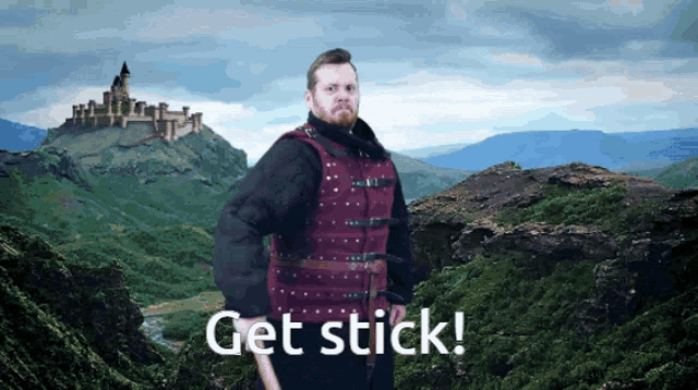 a man in a red vest stands in front of a mountain with the words get stick written on the bottom