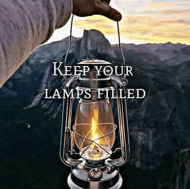 a person is holding a lantern with the words keep your lamps filled in the background .