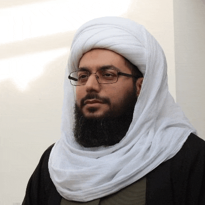 a bearded man wearing glasses and a white turban