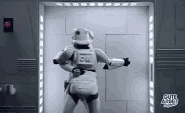 a storm trooper is standing in a doorway in a room .