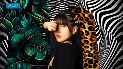 a girl with a leopard print covering her face in front of an optical illusion