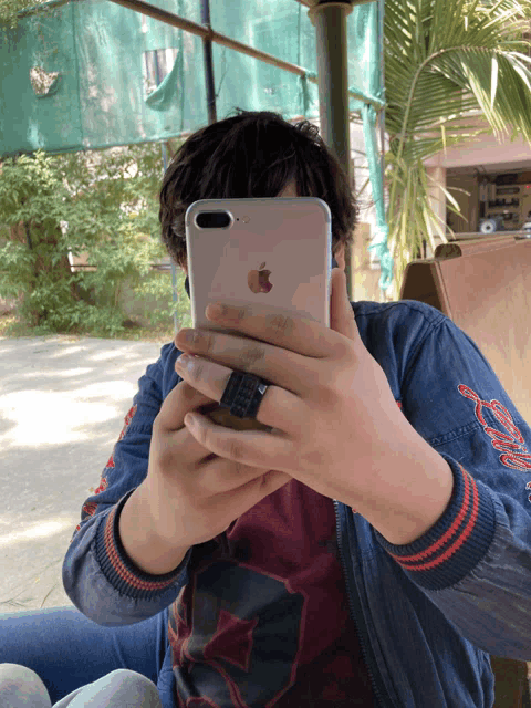 a person taking a picture of themselves with their iphone