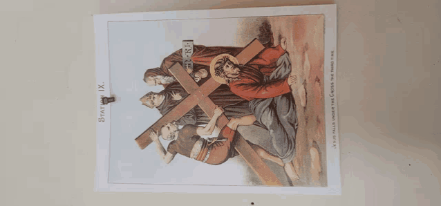 a picture of jesus carrying a cross with the words " jesus falls under the cross " on the bottom