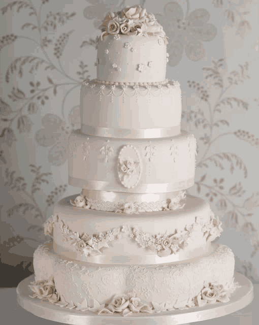 a white wedding cake with flowers on top of it