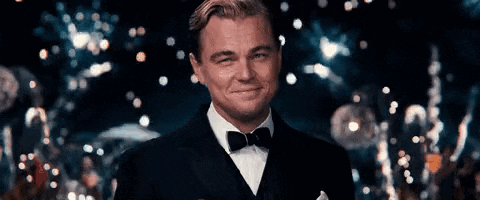 leonardo dicaprio is wearing a tuxedo and bow tie and smiling .