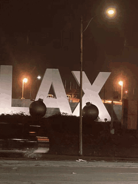 a large white lax sign with christmas ornaments in front of it