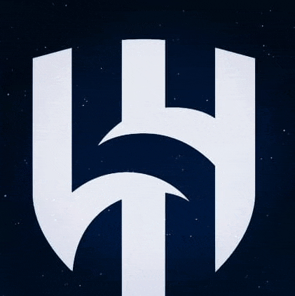 a white letter h in the shape of a shield against a dark blue background .