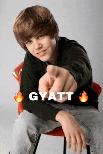 justin bieber is sitting in a chair and pointing at the camera with the word gyatt above him