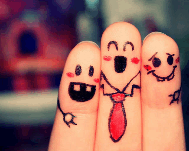 three fingers with faces drawn on them including one wearing a red tie