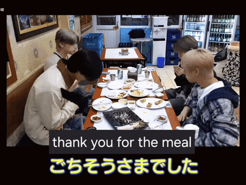 a group of people are sitting at a table with plates of food and the words thank you for the meal in blue letters