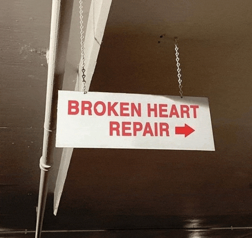 a sign that says broken heart repair with an arrow pointing right