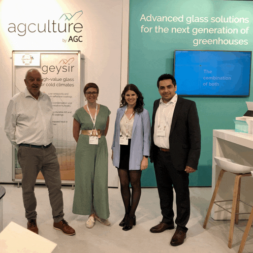 a group of people stand in front of a sign that says agculture by agc