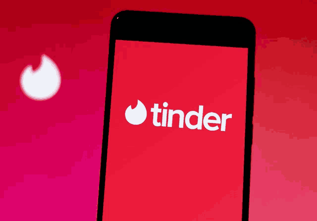 a cell phone with the tinder logo on it