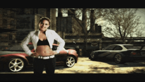 a woman stands in front of a row of cars