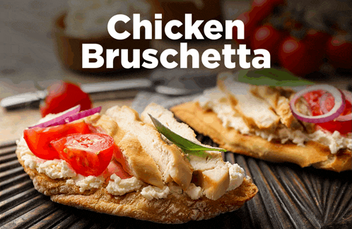 a chicken bruschetta sandwich with tomatoes and onions on a wooden cutting board