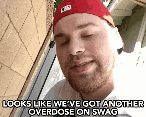 a man wearing a red hat and a white shirt says " looks like we 've got another overdose on swag "