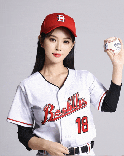 a woman wearing a baseball jersey with the number 18