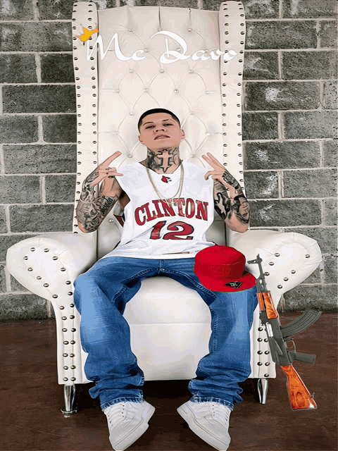 a man in a clinton jersey sits in a white chair